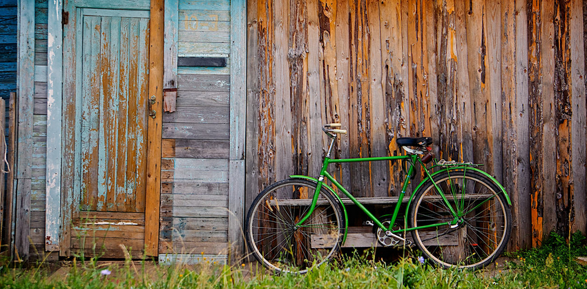 Old wooden wall and green bicycle